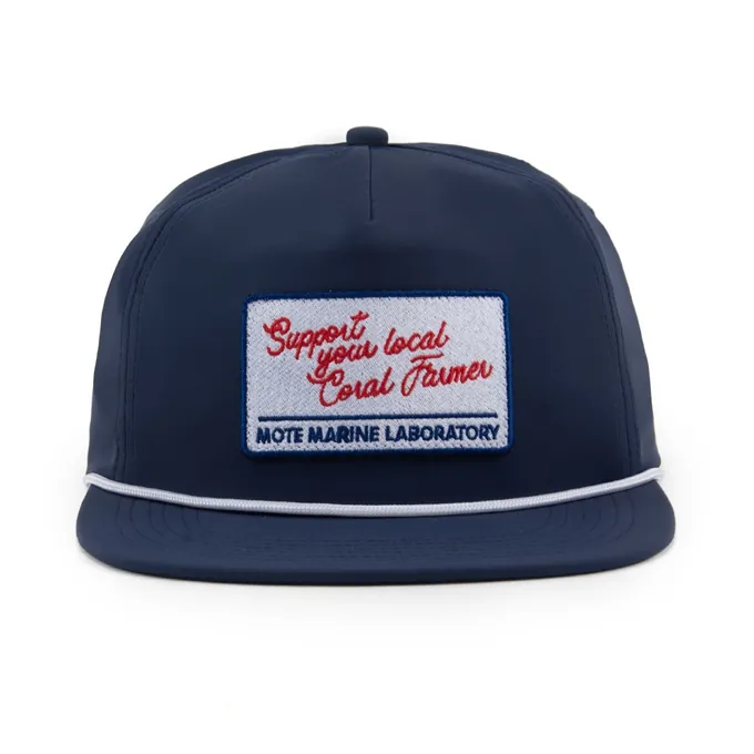 The navy Mote Marine cap, front view, with the Support your local Coral Farmer embroidered patch and white rope
